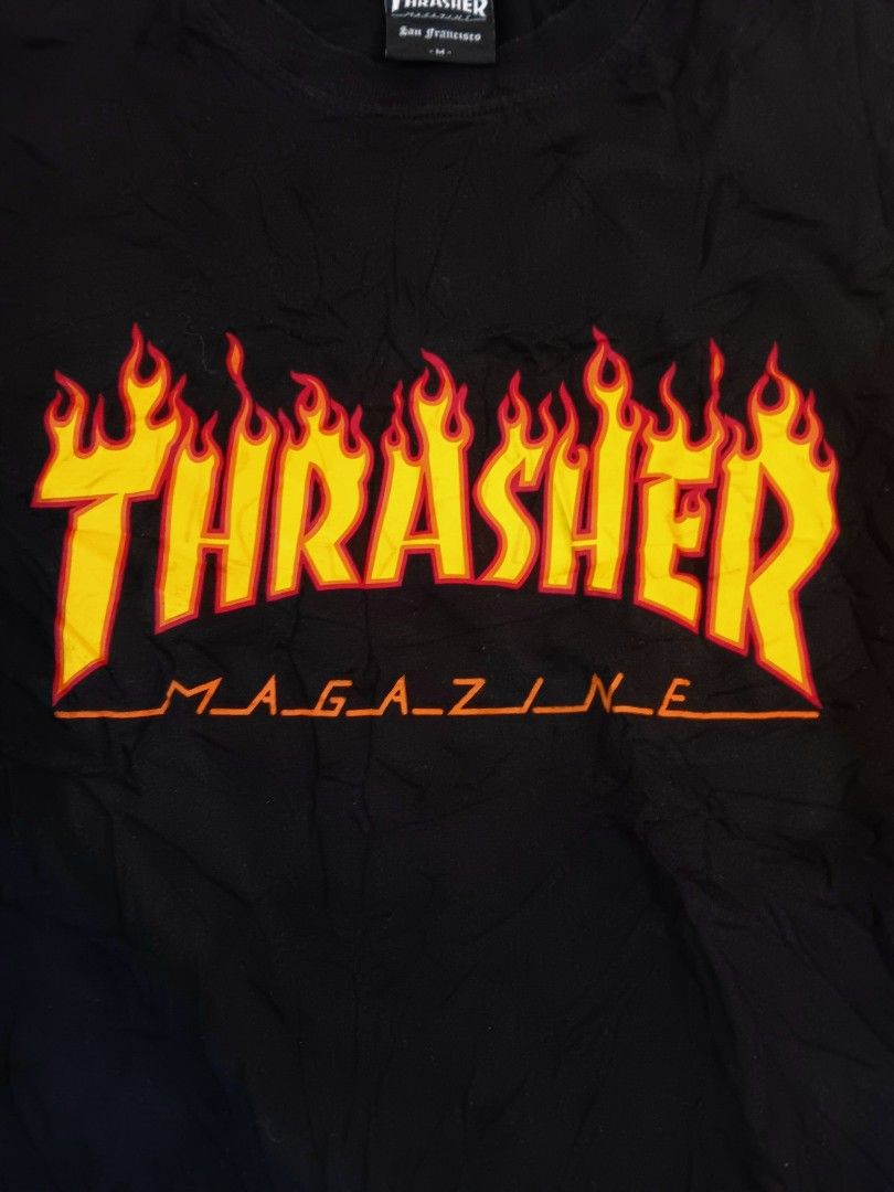 Thrasher Flame Logo Black T-Shirt (Category: Tshirts & Polo Shirts ) located in Manila. Submitted by mysticowl-11c6 (Listing ID 1469205873, Image 3). Description: - Brand: Thrasher Magazine - Color: Classic Black - Graphic: Iconic flame logo on chest - Size: Medium - Material: 100% Cotton - Details: San Francisco neck tag and red side hem tag - Production Date: January 2023 - Condition: Brand new/Mint - Dimes 19W 27L - Color rate 10/10 - Freeship
