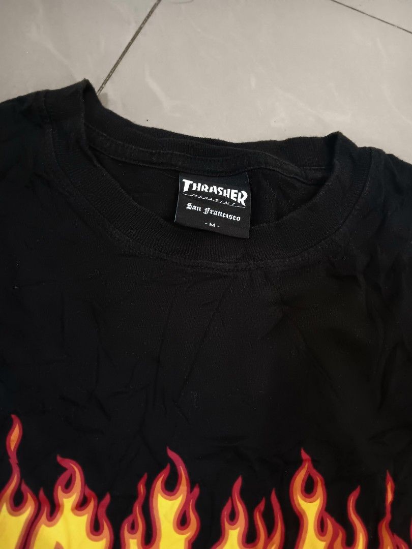 Thrasher Flame Logo Black T-Shirt (Category: Tshirts & Polo Shirts ) located in Manila. Submitted by mysticowl-11c6 (Listing ID 1469205873, Image 2). Description: - Brand: Thrasher Magazine - Color: Classic Black - Graphic: Iconic flame logo on chest - Size: Medium - Material: 100% Cotton - Details: San Francisco neck tag and red side hem tag - Production Date: January 2023 - Condition: Brand new/Mint - Dimes 19W 27L - Color rate 10/10 - Freeship