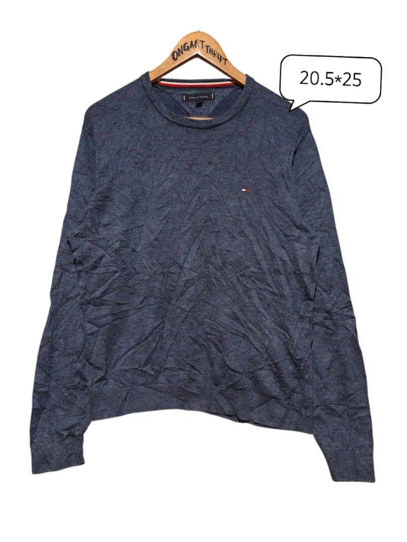 Tommy Hilfiger Blue Knit Sweater Size M (Category: Coats, Jackets and Outerwear) located in Maasim. Submitted by ukayganda25 (Listing ID 1469270912, Image 1). Description: - Brand: Tommy Hilfiger - Color: Dark blue marl knit - Size: Medium (20.5" pit to pit x 25" length) - Details: Ribbed collar with iconic red, white, and black stripes, embroidered chest logo - Condition: Clean overall, great pre-loved piece.