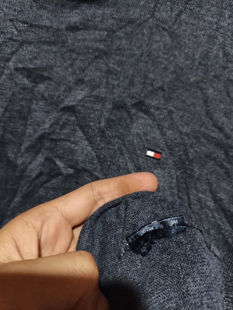 Tommy Hilfiger Blue Knit Sweater Size M (Category: Coats, Jackets and Outerwear) located in Maasim. Submitted by ukayganda25 (Listing ID 1469270912, Image 3). Description: - Brand: Tommy Hilfiger - Color: Dark blue marl knit - Size: Medium (20.5" pit to pit x 25" length) - Details: Ribbed collar with iconic red, white, and black stripes, embroidered chest logo - Condition: Clean overall, great pre-loved piece.