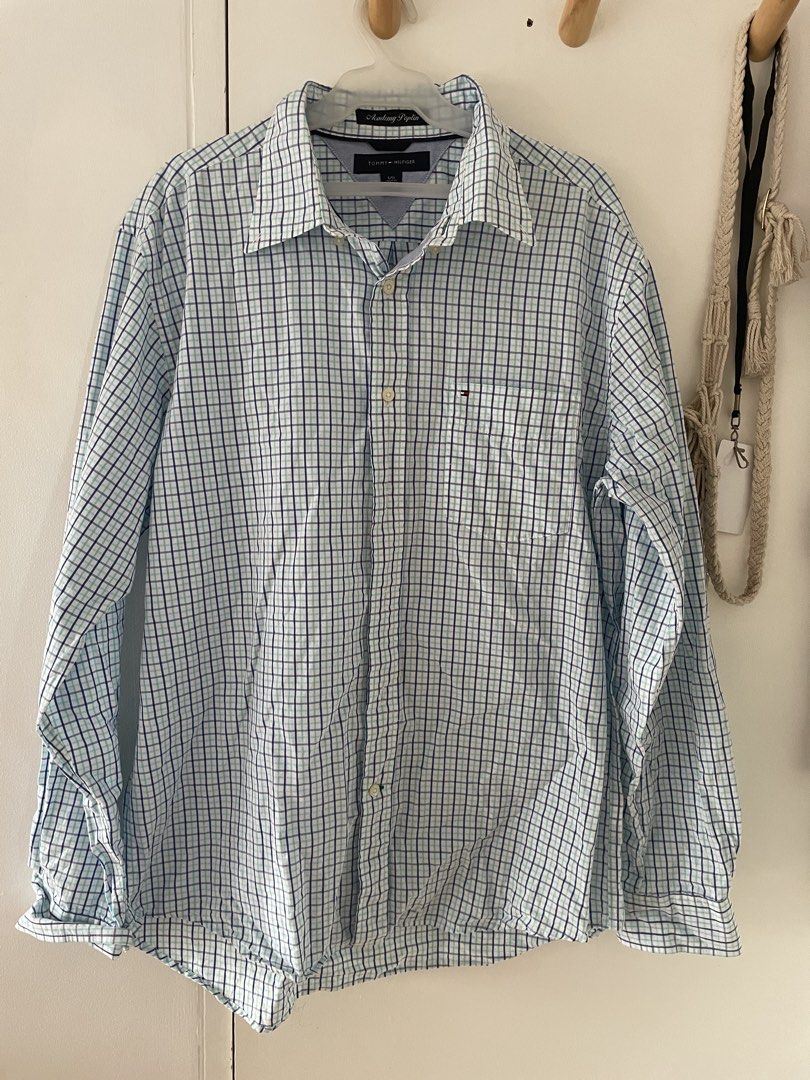 Tommy Hilfiger Long Sleeve - L (Category: Formal Shirts) located in Cainta. Submitted by pnedp2022 (Listing ID 1469212587, Image 1). Description: - Brand: Tommy Hilfiger - Style: Academy Poplin Long Sleeve Button-Up Shirt - Color: White base with blue and mint green plaid grid pattern - Size: Large - Material: Lightweight and breathable cotton poplin - Features: Left chest pocket with small embroidered logo flag, button-up front, and classic coll
