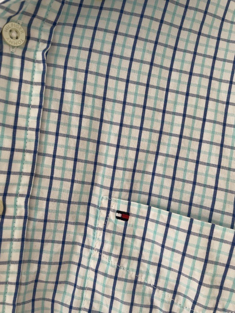 Tommy Hilfiger Long Sleeve - L (Category: Formal Shirts) located in Cainta. Submitted by pnedp2022 (Listing ID 1469212587, Image 2). Description: - Brand: Tommy Hilfiger - Style: Academy Poplin Long Sleeve Button-Up Shirt - Color: White base with blue and mint green plaid grid pattern - Size: Large - Material: Lightweight and breathable cotton poplin - Features: Left chest pocket with small embroidered logo flag, button-up front, and classic coll