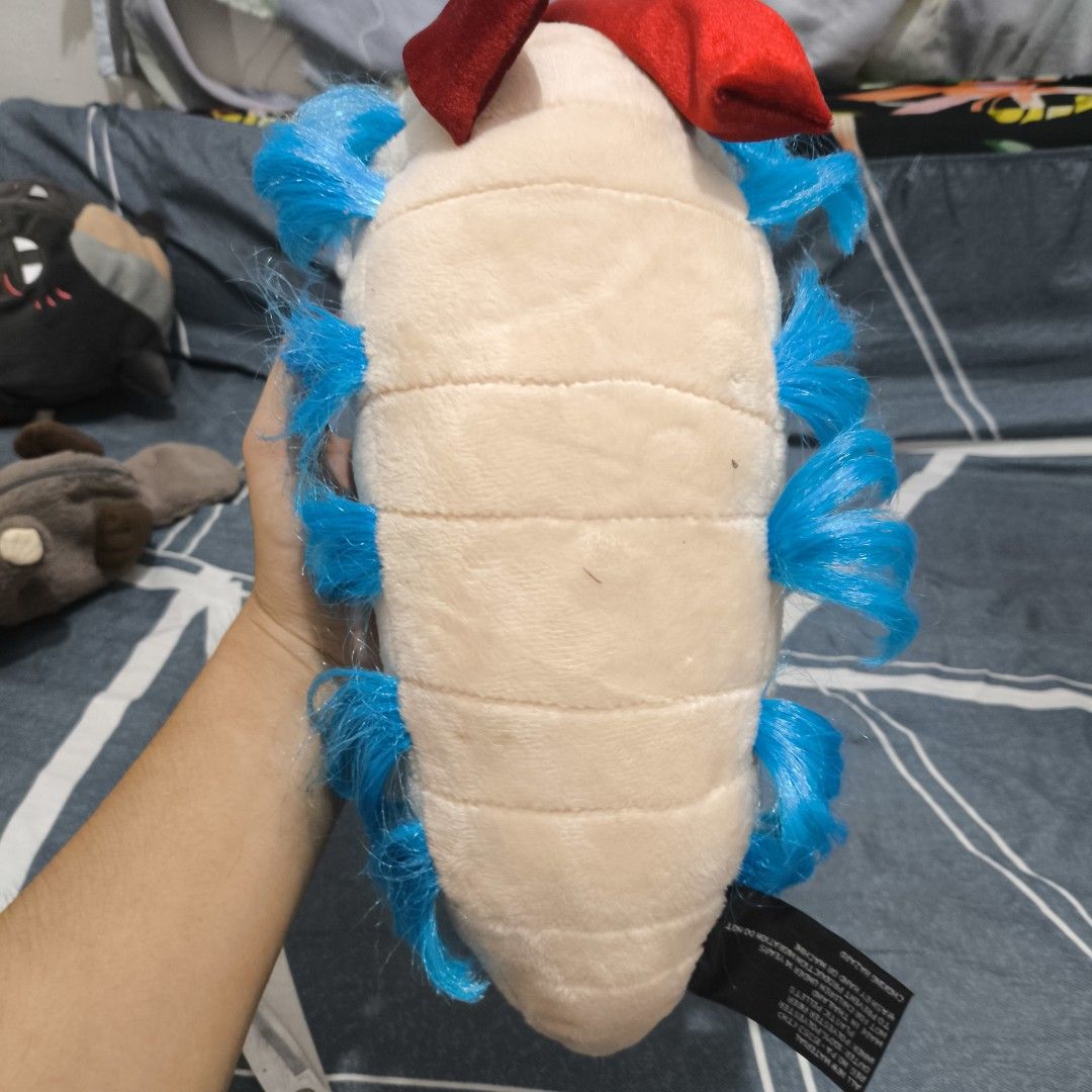 Toy Vault The Worm From Labyrinth Plush 2010 (Category: Plushies & Soft Toys) located in Quezon City. Submitted by boitresures (Listing ID 1469297083, Image 3). Description: - Item: Labyrinth Worm Plush by Toy Vault - Release Year: 2010 (Verified via original tag) - Condition: Brand new with original tag attached - Key Features: Iconic blue hair and fluffy blue side tufts, red scarf accessory - Design: Segmented body with detailed light beige and