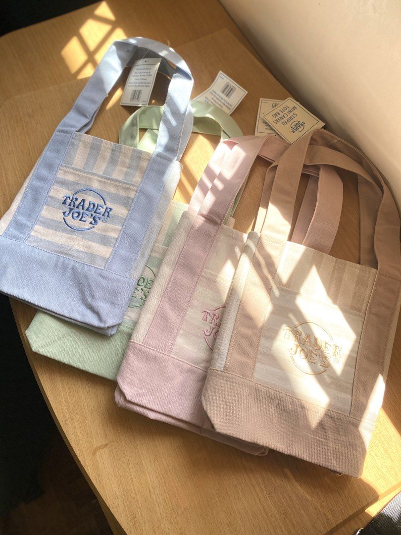 Trader Joe's Striped Mini Canvas Tote Bag (Category: Tote Bags) located in Batangas. Submitted by lux_kimmy (Listing ID 1469208123, Image 2). Description: - 100% Authentic Trader Joe's Mini Canvas Tote Bag - Brand new with tags (BNWT) - Available pastel colors: Pink, Light Green, Blue, and Beige - Features durable canvas handles, matching bottom panel, and handy front pocket with embroidered logo - Perfect compact size for daily errands, lunch ba