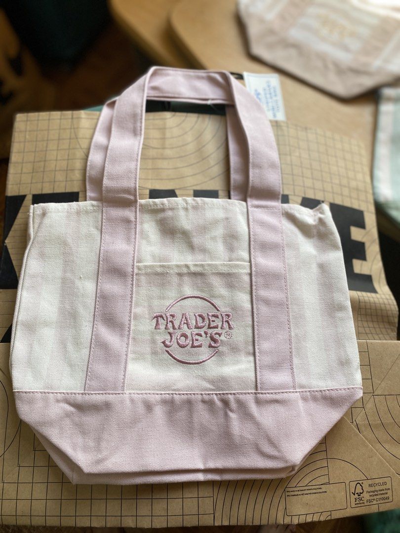Trader Joe's Striped Mini Canvas Tote Bag (Category: Tote Bags) located in Batangas. Submitted by lux_kimmy (Listing ID 1469208123, Image 3). Description: - 100% Authentic Trader Joe's Mini Canvas Tote Bag - Brand new with tags (BNWT) - Available pastel colors: Pink, Light Green, Blue, and Beige - Features durable canvas handles, matching bottom panel, and handy front pocket with embroidered logo - Perfect compact size for daily errands, lunch ba