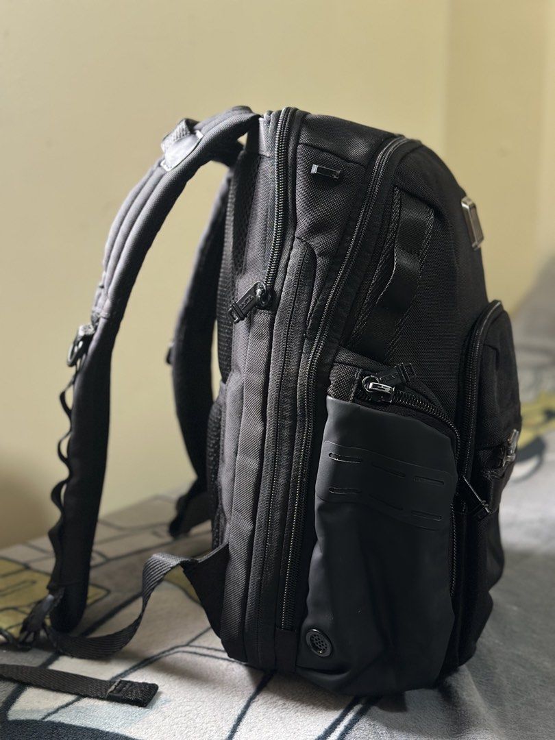 TUMI Alpha Bravo Nathan Backpack Black KOBE Monogram (Category: Luxury Bags & Wallets) located in Baguio. Submitted by annecicat (Listing ID 1469227668, Image 3). Description: - Brand: Tumi Alpha Bravo - Material: Solid black ballistic nylon - Customization: Metal plaque engraved with the name 'KOBE' - Storage: Multiple exterior zippered compartments, side utility pockets, and clean interior lining - Comfort: Padded shoulder straps with D-rings, 