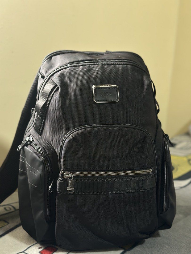 TUMI Alpha Bravo Nathan Backpack Black KOBE Monogram (Category: Luxury Bags & Wallets) located in Baguio. Submitted by annecicat (Listing ID 1469227668, Image 1). Description: - Brand: Tumi Alpha Bravo - Material: Solid black ballistic nylon - Customization: Metal plaque engraved with the name 'KOBE' - Storage: Multiple exterior zippered compartments, side utility pockets, and clean interior lining - Comfort: Padded shoulder straps with D-rings, 