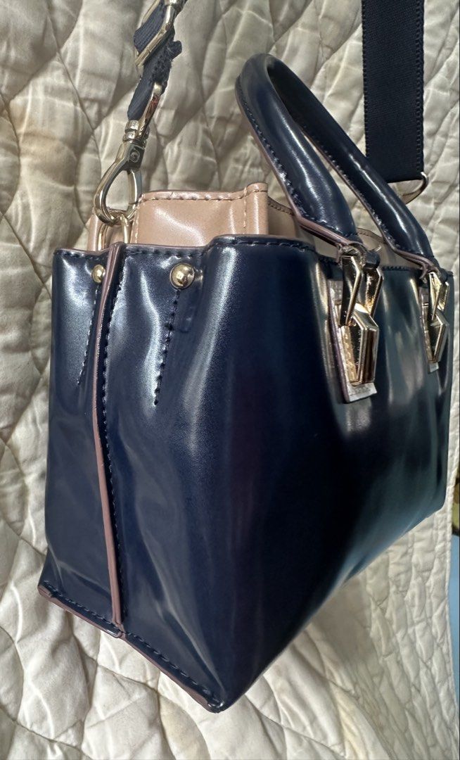 2 Tone Sling Bag two way from Japan! (Category: Luxury Bags & Wallets) located in Santa Rosa. Submitted by esplanamur03635 (Listing ID 1469233056, Image 2). Description: Chic two-tone navy blue and taupe patent handbag and Sling bag Super gold hardwares detachable/adjustable webbed strap structured, organized interior Clean inside and out 3 compartments mid zip closure/2 magnetic clasp sides small but roomy no flaws good condition very minimal si