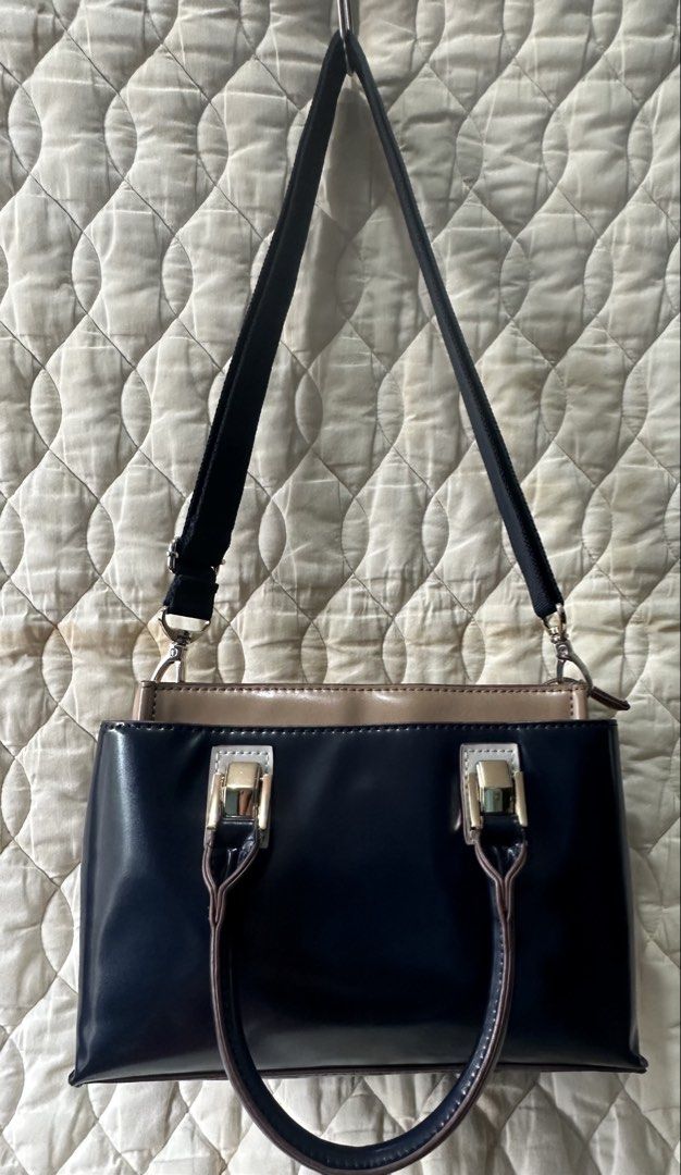 2 Tone Sling Bag two way from Japan! (Category: Luxury Bags & Wallets) located in Santa Rosa. Submitted by esplanamur03635 (Listing ID 1469233056, Image 1). Description: Chic two-tone navy blue and taupe patent handbag and Sling bag Super gold hardwares detachable/adjustable webbed strap structured, organized interior Clean inside and out 3 compartments mid zip closure/2 magnetic clasp sides small but roomy no flaws good condition very minimal si
