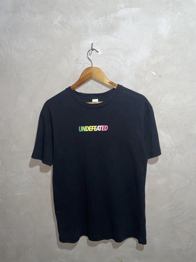 Undefeated Black T-Shirt with Gradient Logo (Category: Tshirts & Polo Shirts ) located in Zamboanga. Submitted by guthens (Listing ID 1469304723, Image 1). Description: Condition- excellent Issue- none Color rate- 9.5/10.