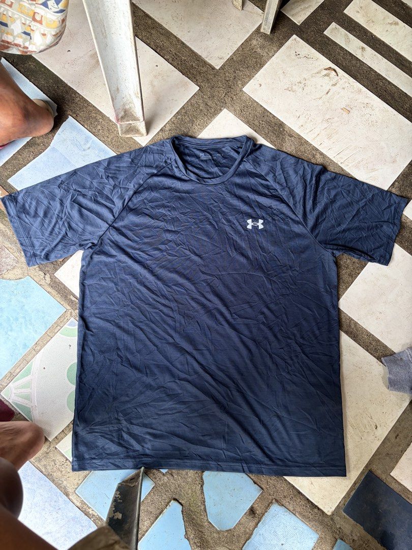 Under Armour Navy Blue Workout T-Shirt (Category: Activewear) located in Manila. Submitted by nickol17 (Listing ID 1469324596, Image 1). Description: - Brand: Under Armour - Color: Navy blue with white UA logo - Style: Short sleeves, crew neck, standard fit - Material: Lightweight and breathable - Condition: Good, needs ironing before use - Best for: Working out or casual daily wear.