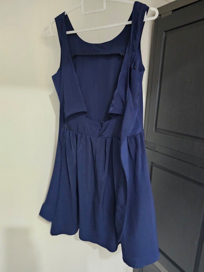 Unicode Navy Blue Flare Dress (Category: Dresses) located in Quezon City. Submitted by alevi (Listing ID 1469187155, Image 2). Description: - Brand: Unicode - Color: Navy blue - Style: Sleeveless dress with flared pleated skirt and open back strap design - Closure: Hidden back zipper - Material: Lightweight and comfortable - Condition: Clean inside and out, great for casual outings or dates.