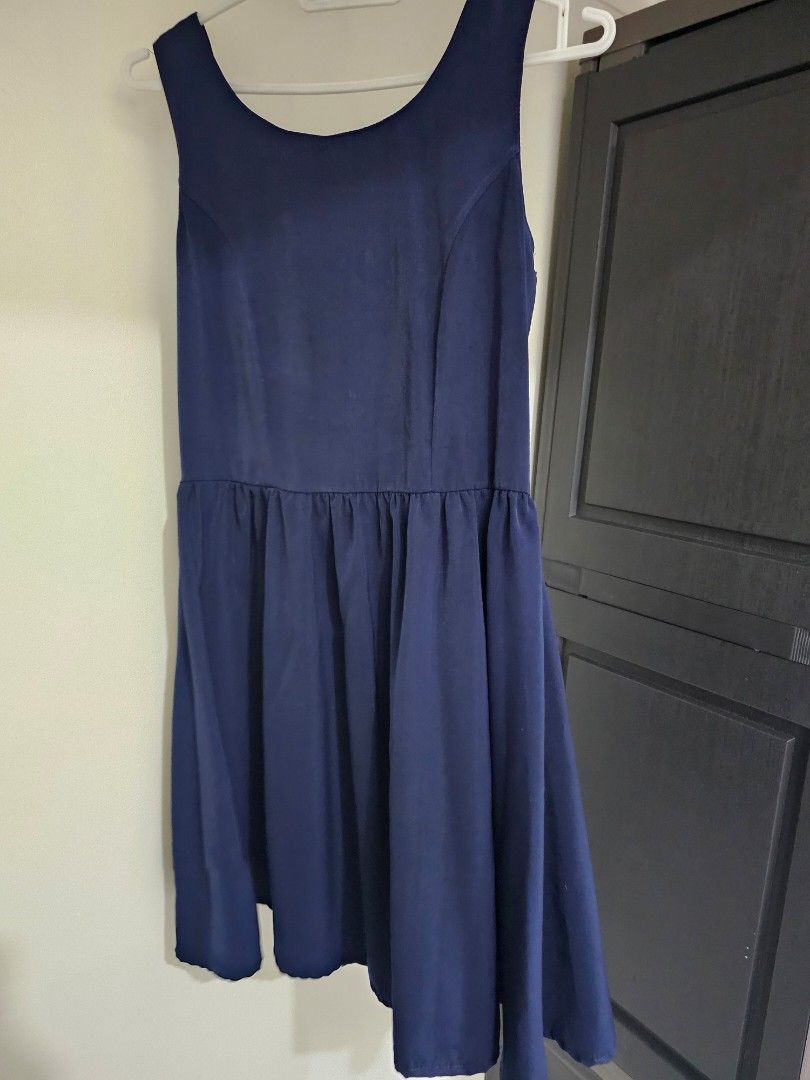 Unicode Navy Blue Flare Dress (Category: Dresses) located in Quezon City. Submitted by alevi (Listing ID 1469187155, Image 1). Description: - Brand: Unicode - Color: Navy blue - Style: Sleeveless dress with flared pleated skirt and open back strap design - Closure: Hidden back zipper - Material: Lightweight and comfortable - Condition: Clean inside and out, great for casual outings or dates.