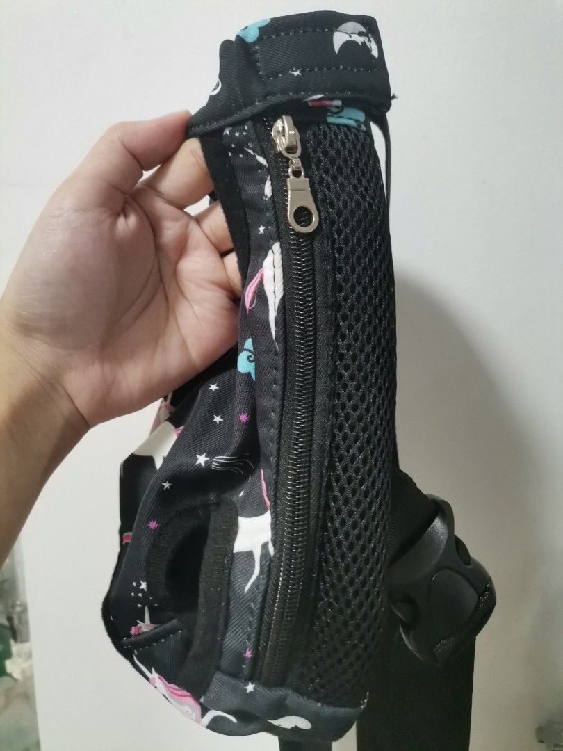 Unicorn Print Pet Carrier Backpack Size S (Category: Backpacks) located in Makati City. Submitted by kookybearsstuff (Listing ID 1469278584, Image 3). Description: - Size S unicorn print pet carrier, ideal for small dogs or cats - Fun black fabric with colorful unicorns, clouds, and stars design - Breathable black mesh side panels for proper ventilation - Secure front zipper closure and adjustable straps with plastic buckle - Material: 65% cotton