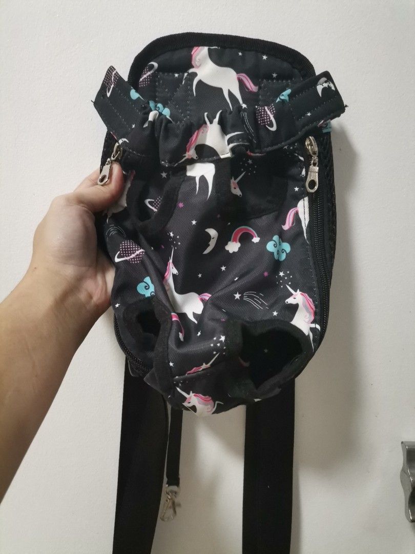 Unicorn Print Pet Carrier Backpack Size S (Category: Backpacks) located in Makati City. Submitted by kookybearsstuff (Listing ID 1469278584, Image 1). Description: - Size S unicorn print pet carrier, ideal for small dogs or cats - Fun black fabric with colorful unicorns, clouds, and stars design - Breathable black mesh side panels for proper ventilation - Secure front zipper closure and adjustable straps with plastic buckle - Material: 65% cotton