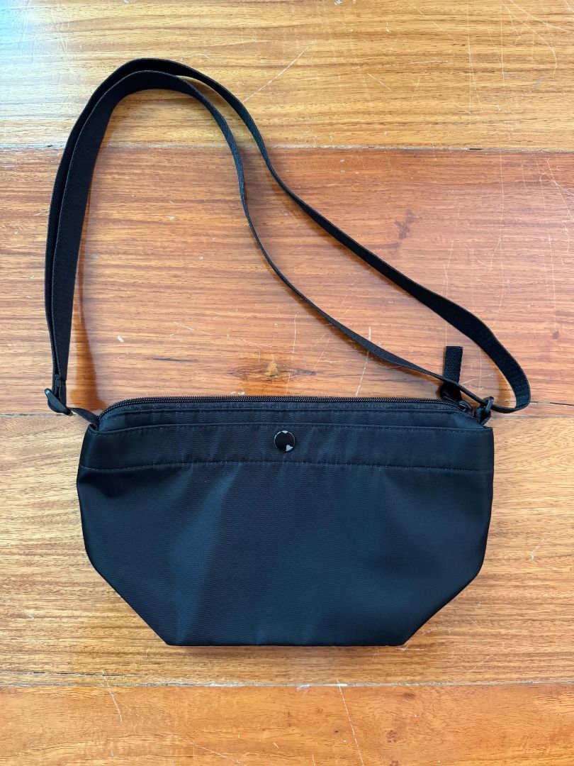 Uniqlo Nylon Mini Shoulder Bag (Category: Cross-body Bags) located in Quezon City. Submitted by scpng (Listing ID 1469220482, Image 1). Description: - Material: Lightweight nylon - Color: Classic black - Closure: Secure zipper top - Strap: Adjustable for custom length - Interior: Fabric-lined with a small inner tag - Condition: Clean, with scratches on the snap button MOP: E-Wallets, Bank Transfers MOD: Same-day delivery (Grab/Lalamove), Gogo Xpr
