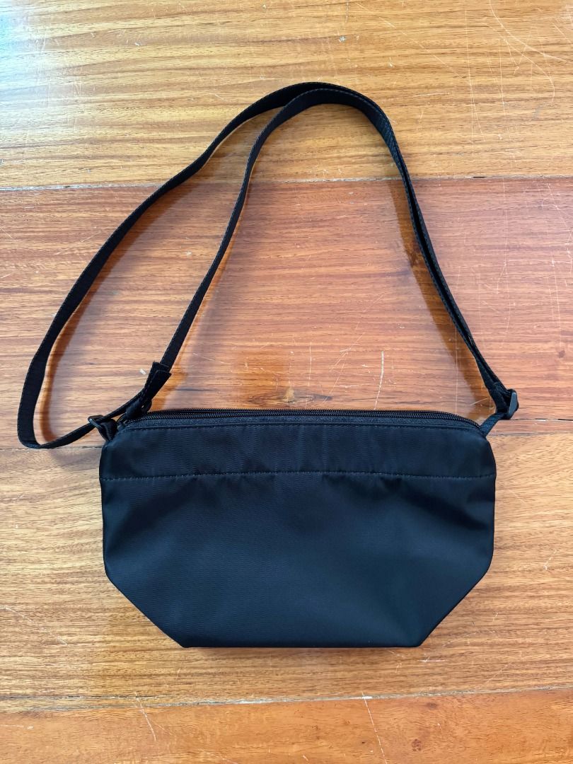 Uniqlo Nylon Mini Shoulder Bag (Category: Cross-body Bags) located in Quezon City. Submitted by scpng (Listing ID 1469220482, Image 2). Description: - Material: Lightweight nylon - Color: Classic black - Closure: Secure zipper top - Strap: Adjustable for custom length - Interior: Fabric-lined with a small inner tag - Condition: Clean, with scratches on the snap button MOP: E-Wallets, Bank Transfers MOD: Same-day delivery (Grab/Lalamove), Gogo Xpr
