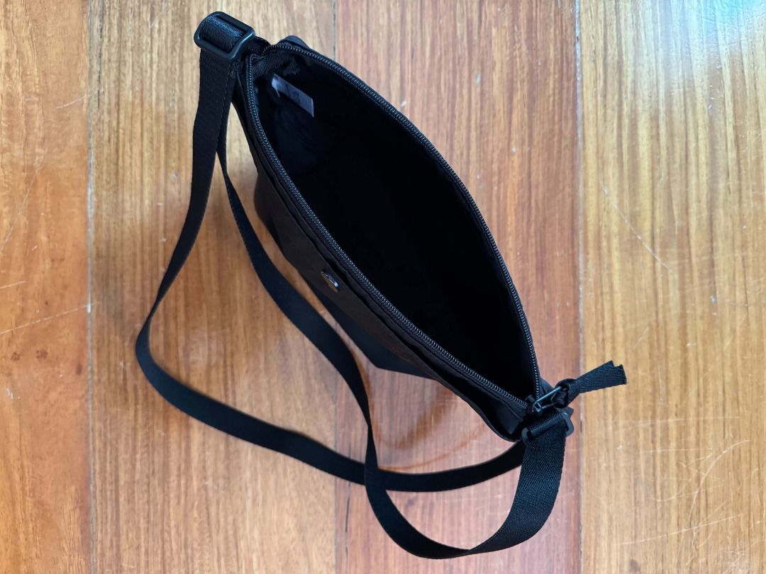 Uniqlo Nylon Mini Shoulder Bag (Category: Cross-body Bags) located in Quezon City. Submitted by scpng (Listing ID 1469220482, Image 3). Description: - Material: Lightweight nylon - Color: Classic black - Closure: Secure zipper top - Strap: Adjustable for custom length - Interior: Fabric-lined with a small inner tag - Condition: Clean, with scratches on the snap button MOP: E-Wallets, Bank Transfers MOD: Same-day delivery (Grab/Lalamove), Gogo Xpr