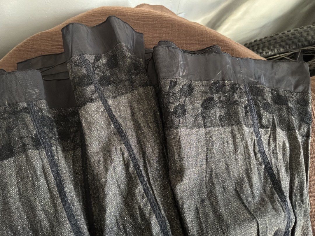 VANEX Designed by Paris Metallic Grey Skirt Size L (Category: Skirts) located in Dumaguete. Submitted by _l1lyy_ (Listing ID 1469244319, Image 2). Description: -Large on tag but better for medium frames VANEX brand skirt, designed in Paris. Size Large on the label. Metallic grey fabric with a textured finish and black lace trim near the top. Panel construction with visible vertical stitching detail. Fully lined interior in black material with a z
