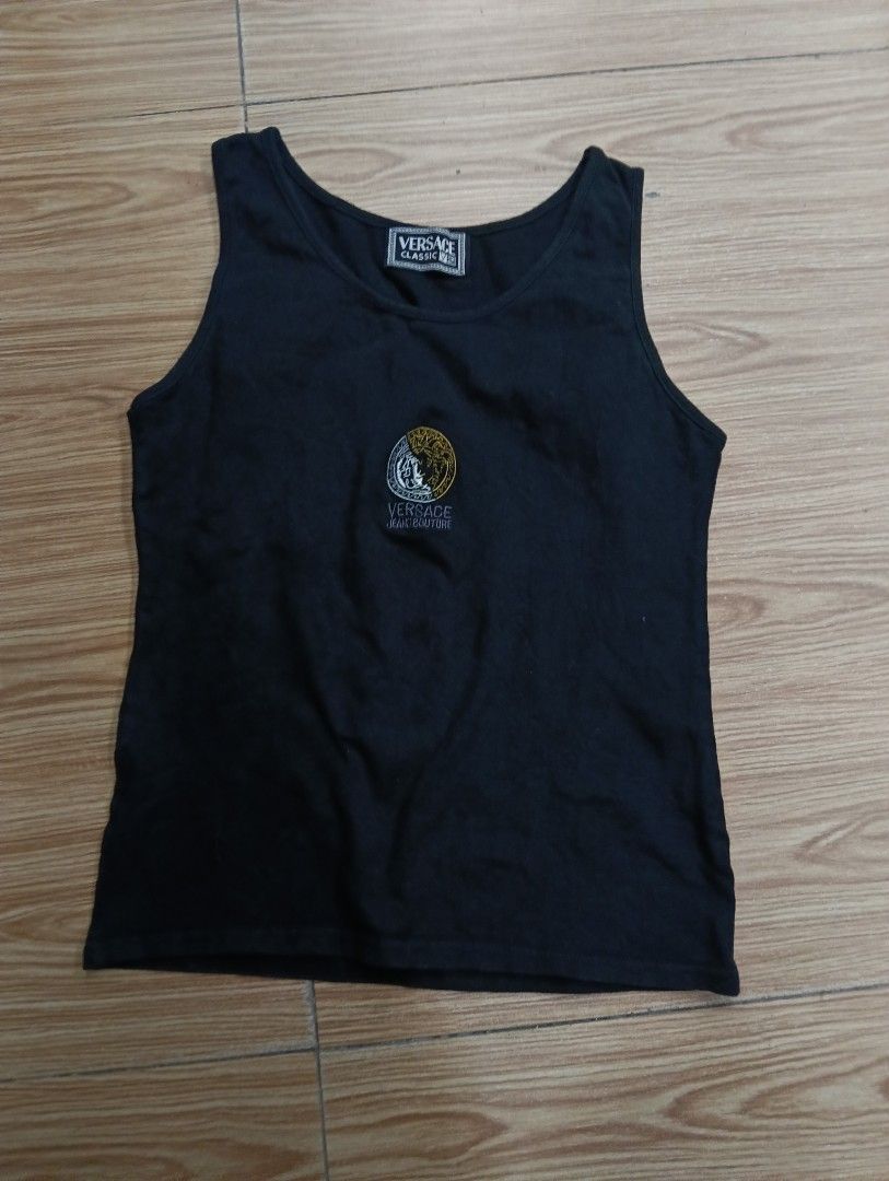 Versace Classic V2 Black Tank Top (Category: Sleeveless) located in Zamboanga. Submitted by nurjim_hajim (Listing ID 1469211982, Image 1). Description: - Brand: Versace Classic V2 - Color: Black - Material: 95% Cotton - Design: Gold and silver embroidered Versace Jeans Couture circular crest logo on the front - Fit: Classic fit - Condition: Clean piece with clear branding.