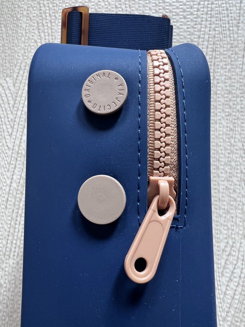 Viajecito XL Bag with Strap (Category: Cross-body Bags) located in Makati City. Submitted by nicole_7 (Listing ID 1469198881, Image 3). Description: - Viajecito - Model/Size: XL Bag with matching strap - Color: Dark Blue with nude/beige zippers and accents - Splash proof, water proof silicone material - Excellent condition, hardly used - Perfect for everyday bag and travel - Dimensions in inches: L 7.5 x W 3.1 x H: 7.