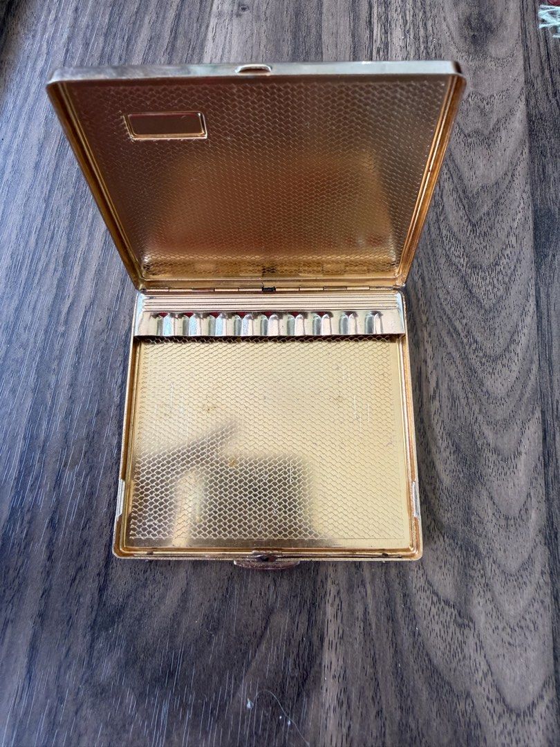 Vintage Crocodile Leather Metal Cigarette Case (Category: Wallets & Card holders) located in Digos. Submitted by old_soul. (Listing ID 1469198714, Image 3). Description: - Material: Brown crocodile leather with gold-tone trim and clasp - Interior: Textured gold finish with a secure built-in cigarette clip - Design: Compact square shape, easily fits in pockets or bags - Condition: Clean interior with minor surface scuffs on the leather from previo