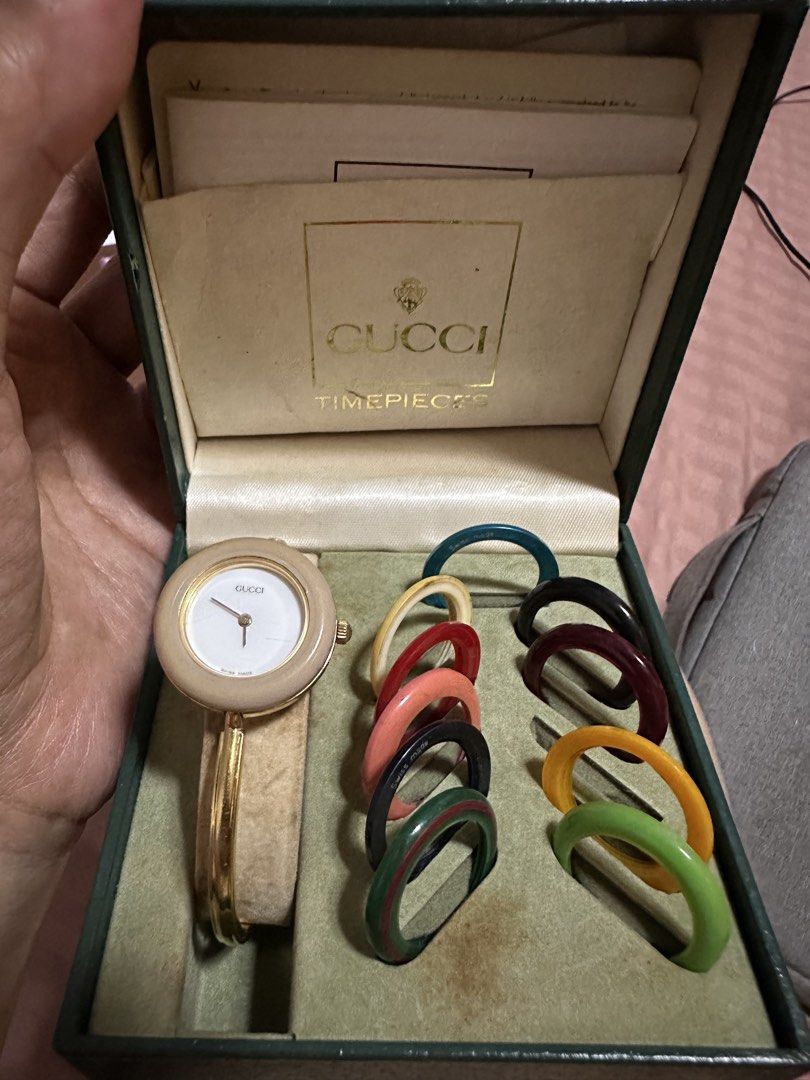 Vintage Gucci Interchangeable Bezel Bangle Watch Box Set (Category: Luxury Watches) located in Bulacan. Submitted by deicalayag (Listing ID 1469235553, Image 1). Description: - 100% Authentic vintage Gucci 11/12.2 bangle watch - Elegant gold tone finish with a classic white round dial - Complete set: includes original green presentation box, warranty papers, and service center booklet - Versatile style: comes with multiple interchangeable colorfu
