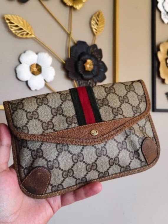 Vintage Gucci Monogram GG Supreme (Category: Luxury Bags & Wallets) located in Manila. Submitted by gutierrez23265 (Listing ID 1469051630, Image 2). Description: - Authentic vintage Gucci -8x5 inches - Classic beige GG monogram canvas with iconic red and green web stripe - Brown leather trim and gold-tone snap closure - Brown fabric-lined interior with original brand tag and serial number - Shows gentle wear consistent with age - Perfect for dail