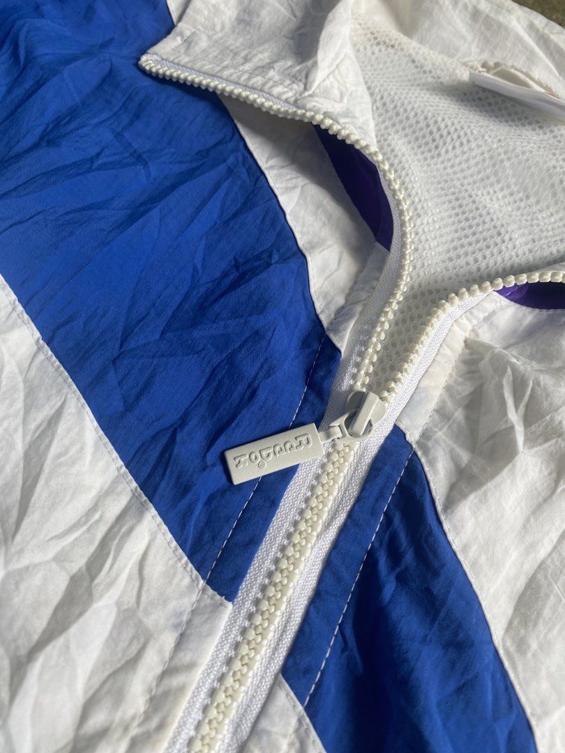 vintage rare reebok windbreaker large (Category: Coats, Jackets and Outerwear) located in Caloocan City. Submitted by remythrift (Listing ID 1469202027, Image 3). Description: - Brand: Reebok - Type: Vintage Rare Windbreaker - Size: Large (L) - Color: White with blue and purple accents - Material: Lightweight nylon with breathable mesh inner lining - Features: Embroidered chest logo, full zip with branded puller, elastic hem and cuffs - Condition