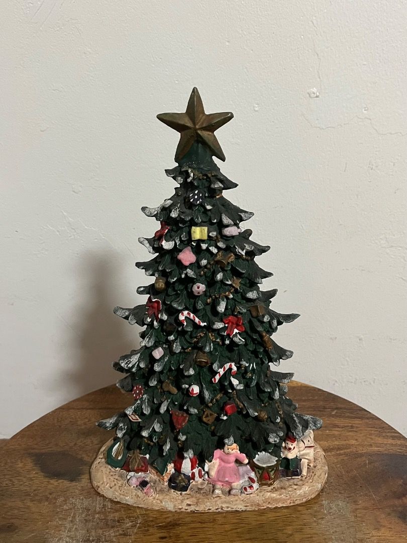 Vintage style tabletop Christmas tree figurine (Category: Vintage Collectibles) located in Cabuyao City. Submitted by rdtrmt (Listing ID 1469185735, Image 2). Description: - Stunning tabletop Christmas tree figurine decorated with snow, ornaments, and candy canes - Topped with a large, eye-catching gold star - Base features a charming arrangement of miniature presents and holiday characters - Crafted from heavy resin/stone material for a sturdy, 