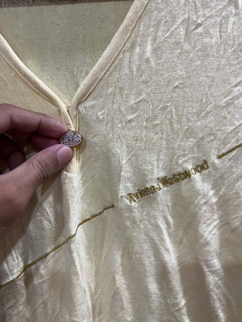 Viveane westwood short sleeve (Category: Shirts) located in Tagum. Submitted by kharldavid38916 (Listing ID 1469344912, Image 3). Description: Size - Small 15 x 22 stretchable Color - light yellow short-sleeve V-neck t-shirt with a button detail and an asymmetric diagonal stitch or wrap-style accent..