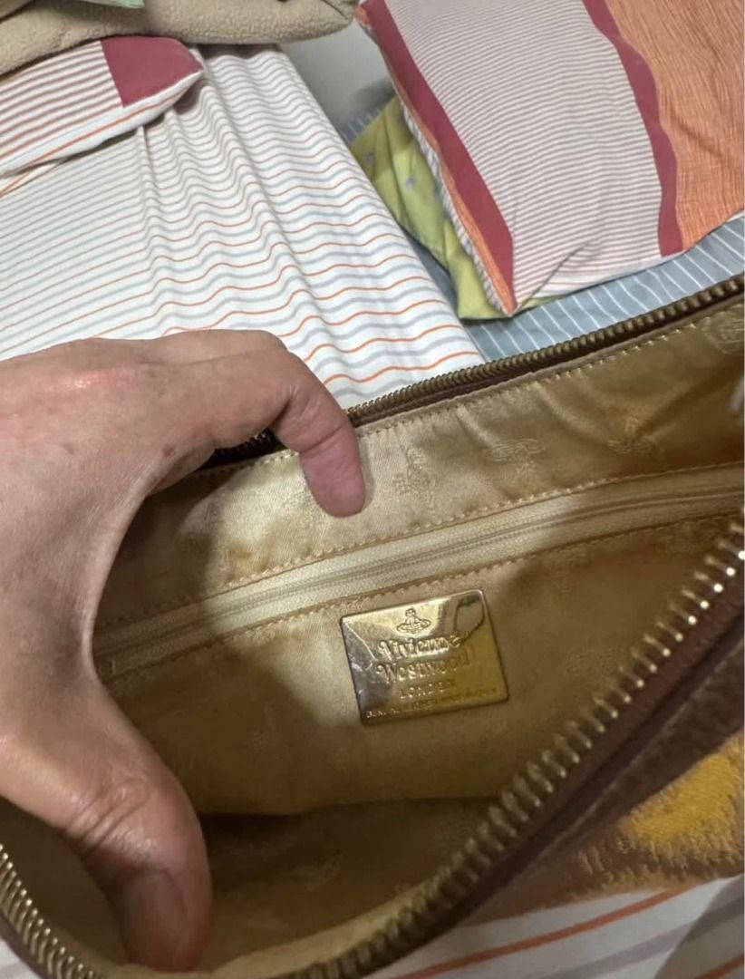 Vivienne Westwood Brown Yellow Pattern Shoulder Bag (Category: Luxury Bags & Wallets) located in Alfonso. Submitted by y2kbuyandsell (Listing ID 1469205394, Image 3). Description: - Brand: Vivienne Westwood London - Material: Brown & yellow patterned fabric with brown textured leather trim - Hardware: Gold-tone iconic orb logo badge and zippers - Closure: Zip-top closure for security - Interior: Fabric-lined with an inner zip pocket and metal bra