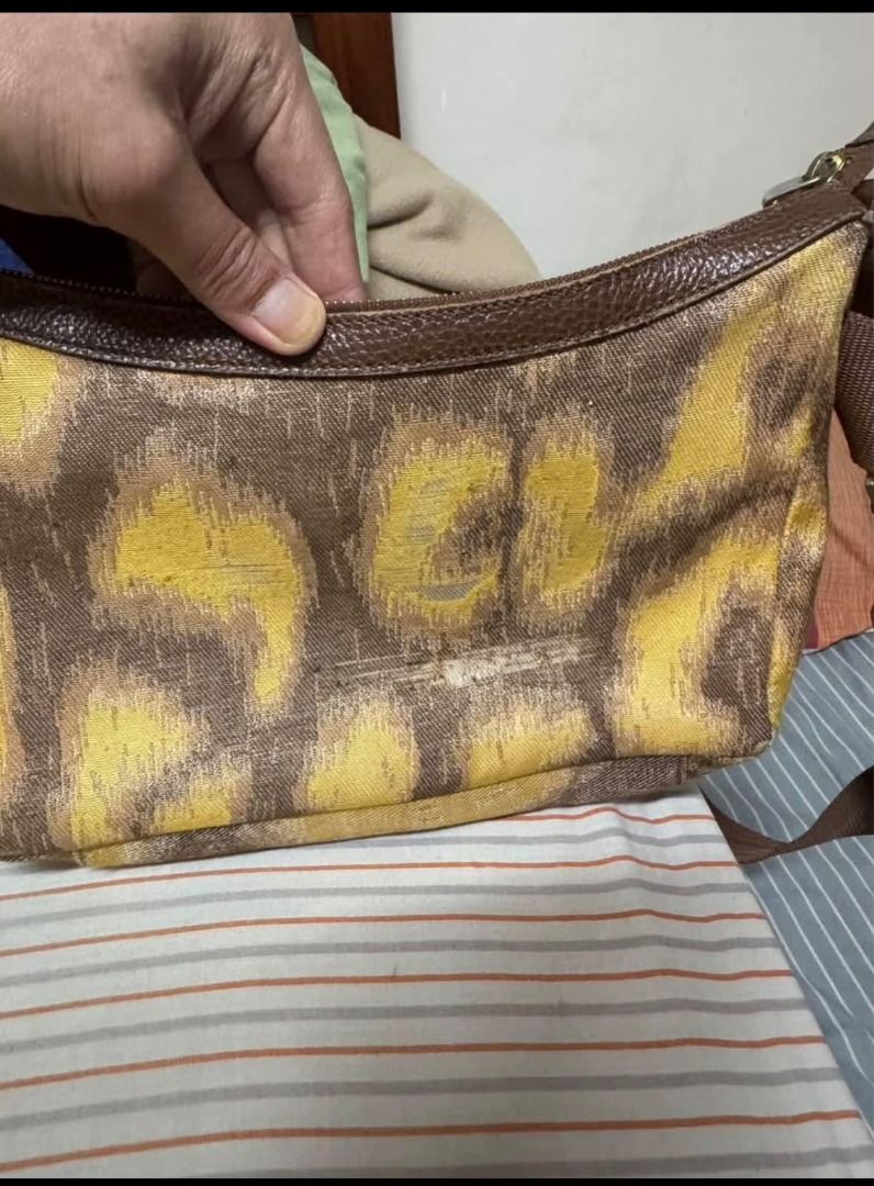 Vivienne Westwood Brown Yellow Pattern Shoulder Bag (Category: Luxury Bags & Wallets) located in Alfonso. Submitted by y2kbuyandsell (Listing ID 1469205394, Image 2). Description: - Brand: Vivienne Westwood London - Material: Brown & yellow patterned fabric with brown textured leather trim - Hardware: Gold-tone iconic orb logo badge and zippers - Closure: Zip-top closure for security - Interior: Fabric-lined with an inner zip pocket and metal bra