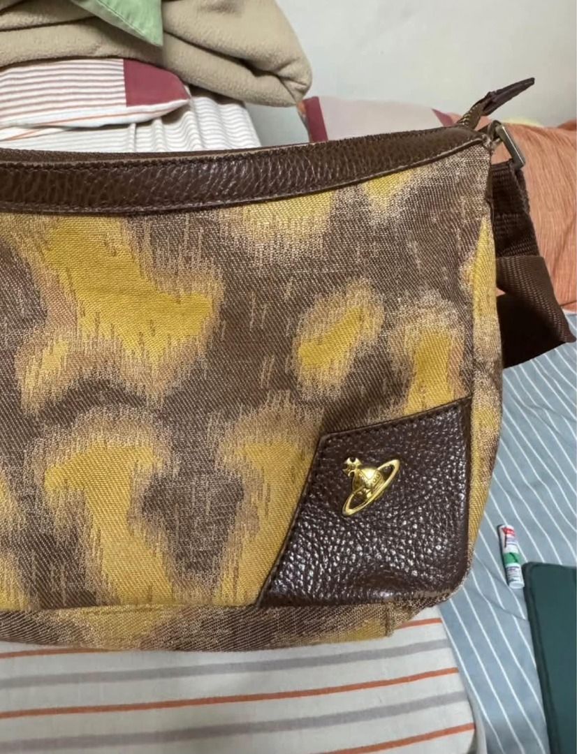 Vivienne Westwood Brown Yellow Pattern Shoulder Bag (Category: Luxury Bags & Wallets) located in Alfonso. Submitted by y2kbuyandsell (Listing ID 1469205394, Image 1). Description: - Brand: Vivienne Westwood London - Material: Brown & yellow patterned fabric with brown textured leather trim - Hardware: Gold-tone iconic orb logo badge and zippers - Closure: Zip-top closure for security - Interior: Fabric-lined with an inner zip pocket and metal bra