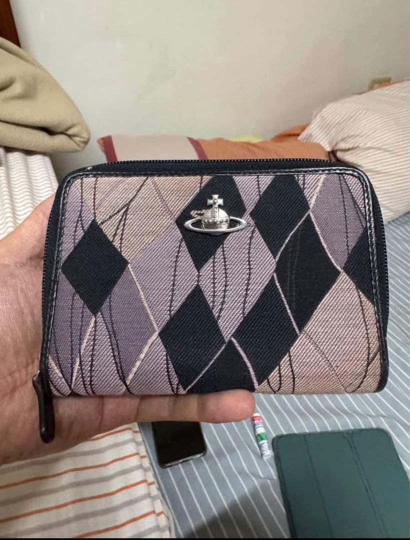 Vivienne Westwood London Argyle Pattern Wallet (Category: Wallets & Card holders) located in Alfonso. Submitted by y2kbuyandsell (Listing ID 1469205453, Image 1). Description: - Brand: Vivienne Westwood London - Design: Classic argyle diamond pattern in black, purple, and beige - Hardware: Iconic silver-tone orb logo on the front - Closure: Secure zip-around design - Interior: Multiple card slots, ID window, dark leather lining, and embossed bran