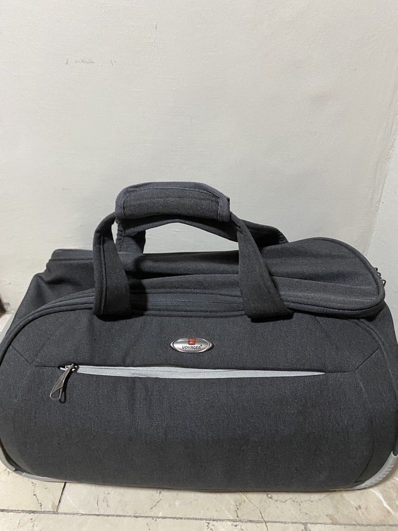 Voyager Rolling Travel Duffel Bag with Handle (Category: Luggage) located in Manila. Submitted by primomirp (Listing ID 1469244478, Image 2). Description: - Brand: Voyager - Color: Stylish dark grey canvas - Mobility: Pull-out top handle and robust wheels for easy towing - Comfort: Carry handles with a padded grip wrap - Storage: Front exterior zippered pocket with contrast zipper tape - Details: Voyager logo patch on the front and side - Conditi