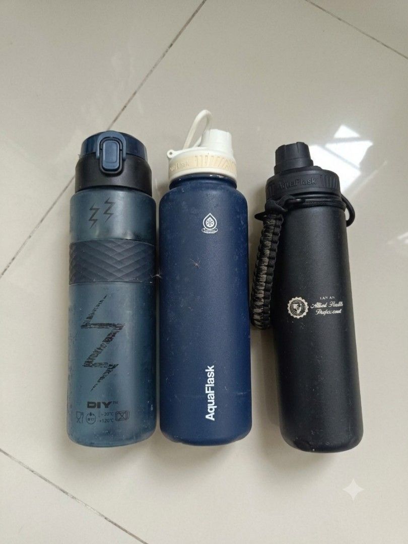 Water Bottles / Flasks (As a 3-Piece Bundle) (Category: Water Bottles & Tumblers) located in Valenzuela. Submitted by justgorjas (Listing ID 1469170058, Image 1). Description: PLEASE READ Price: ₱650 (price for all 3) 1. Dark Blue "DIY" Sports Water Bottle Price: ₱50 (Suggested) Brand: DIY Size: Approx. 22–24 oz (600–700 mL) flaws: Light surface scuffs, worn lightning print, minor discoloration. 2. Matte Navy Blue AquaFlask Price: ₱350 SOLO BUY B