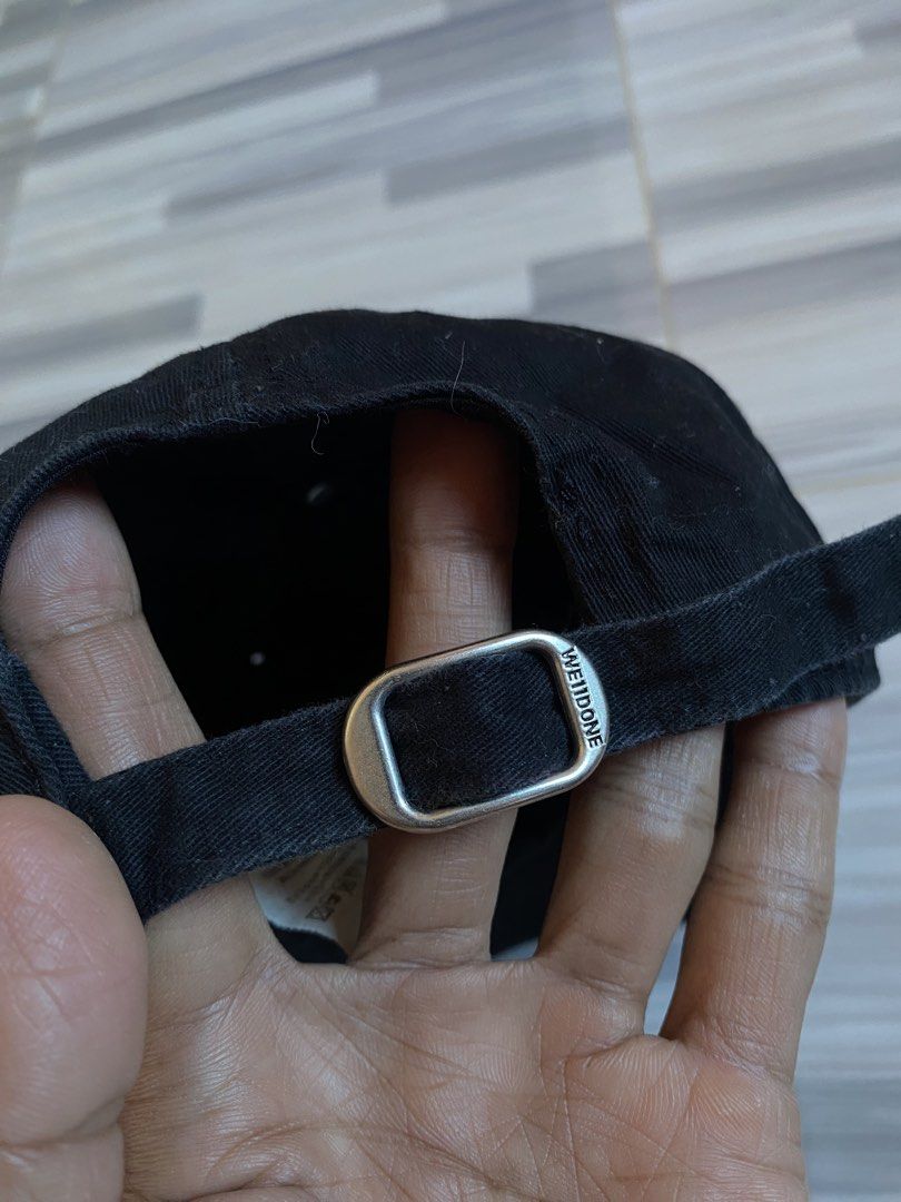 We11done Black Baseball Cap (Category: Caps & Hats) located in Bayambang. Submitted by vintagestuffph (Listing ID 1469198993, Image 2). Description: - Brand: We11done - Color: Black with blue embroidered logo - Material: 100% cotton (inside tags intact) - Size: One size fits all (adjustable metal strap with branded buckle) - Condition: Great everyday streetwear piece - Mode of Payment: GCash, BPI, or Bank Transfer - Shipping: Via J&T Express or S
