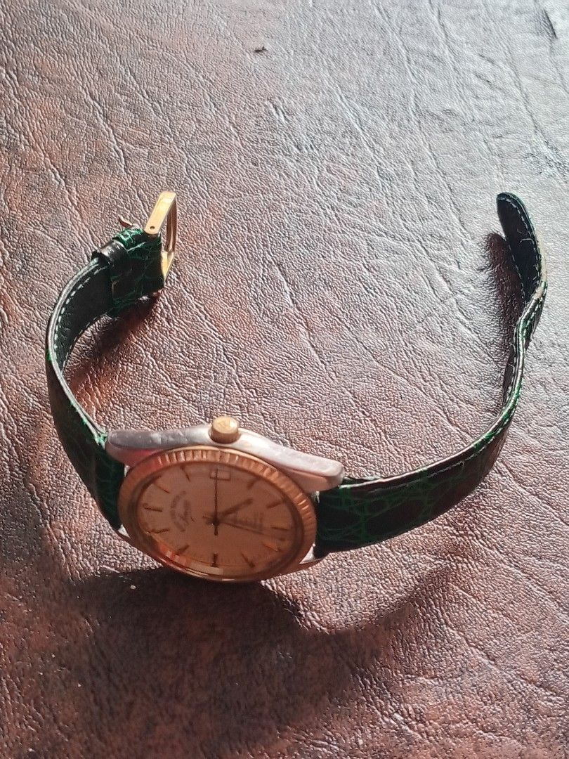 West End Watch Co Sowar Prima Automatic Watch (Category: Men's Watches) located in Bacoor. Submitted by happydolphin.239038 (Listing ID 1469181715, Image 3). Description: - Brand: West End Watch Co Sowar Prima - Movement: Swiss-made automatic, 25 jewels - Dial: Champagne with date window at 3 o'clock - Bezel & Crown: Gold-toned fluted bezel and signed logo crown - Case Back: Stamped with ref. numbers K 5047 and 5838 - Strap: Patterned green leath