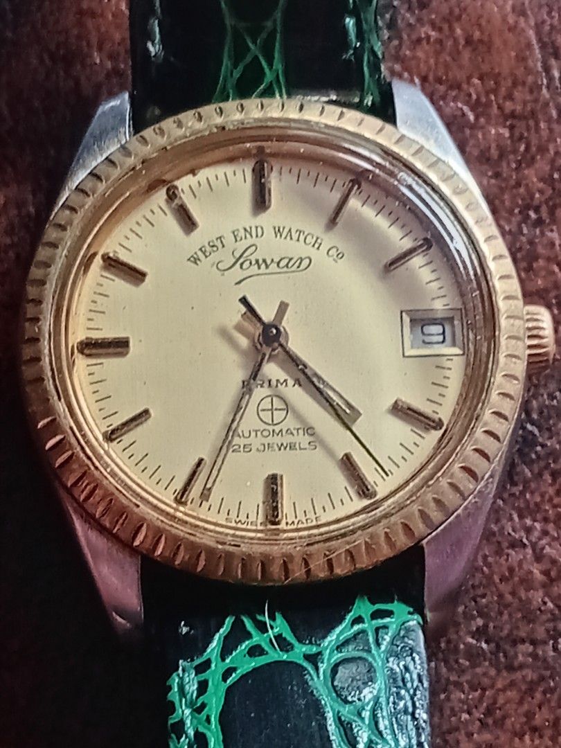 West End Watch Co Sowar Prima Automatic Watch (Category: Men's Watches) located in Bacoor. Submitted by happydolphin.239038 (Listing ID 1469181715, Image 1). Description: - Brand: West End Watch Co Sowar Prima - Movement: Swiss-made automatic, 25 jewels - Dial: Champagne with date window at 3 o'clock - Bezel & Crown: Gold-toned fluted bezel and signed logo crown - Case Back: Stamped with ref. numbers K 5047 and 5838 - Strap: Patterned green leath