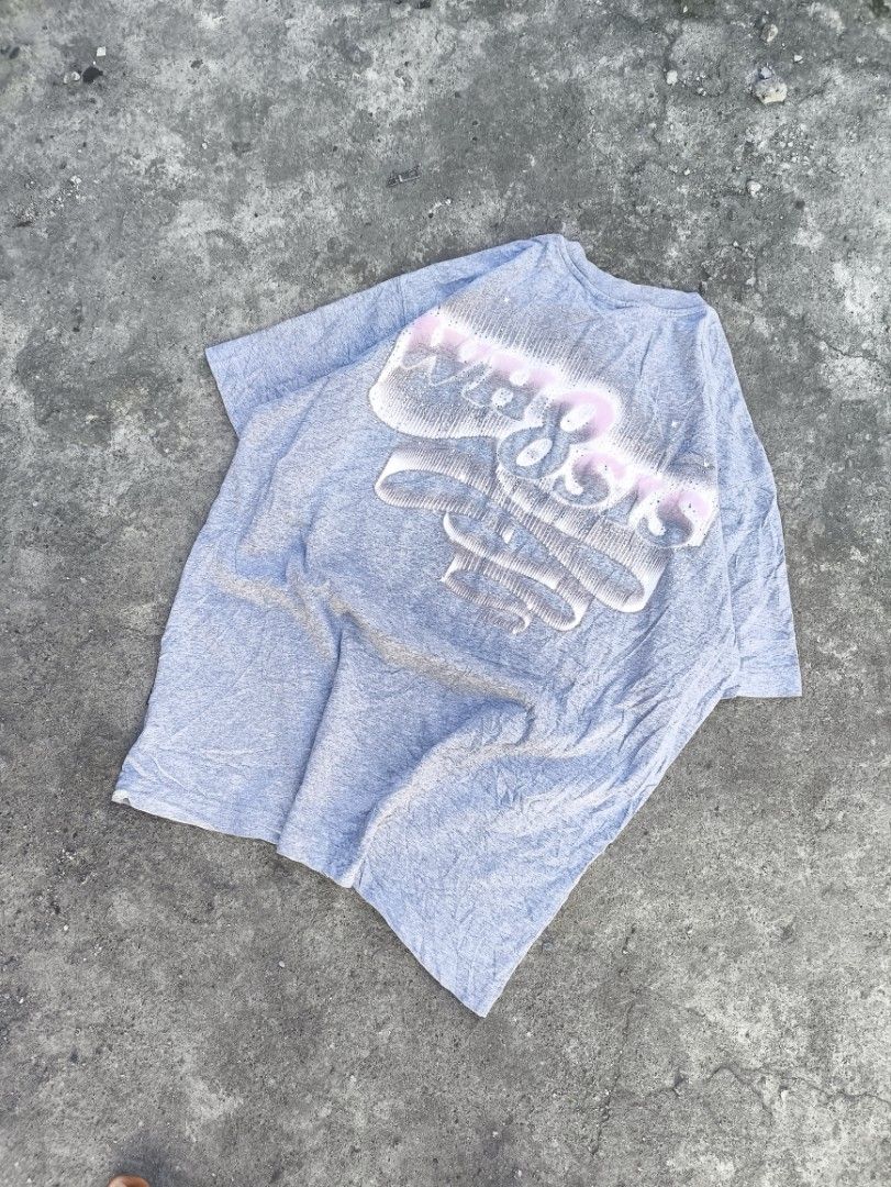WH8SIS Grey Graphic Tee Size M (Category: Tshirts & Polo Shirts ) located in Manila. Submitted by maryaganda (Listing ID 1469222890, Image 1). Description: - Brand: WH8SIS - Size: M (170/88A) - Relaxed fit - Material: 100% Cotton, Made in China - Design: Large graphic print with pink & blue detailing on the back, plus a smaller print on the front chest - Special Feature: Funny care label reading 'You can wash it any fucking way'.