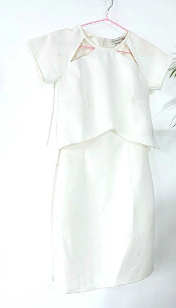 White Dress (Category: Dresses) located in Pasig City. Submitted by ionosphere928 (Listing ID 1469197989, Image 1). Description: - Brand: Apartment 8 Clothing - Color: White - Size/Fit: Straight pencil skirt silhouette - Design: Short sleeves, layered bodice with trendy shoulder cutouts - Closure: Back neck zip closure - Material/Condition: Clean, structured fabric with no damage found - Occasion: Ideal for formal events, parties, or dinner dates