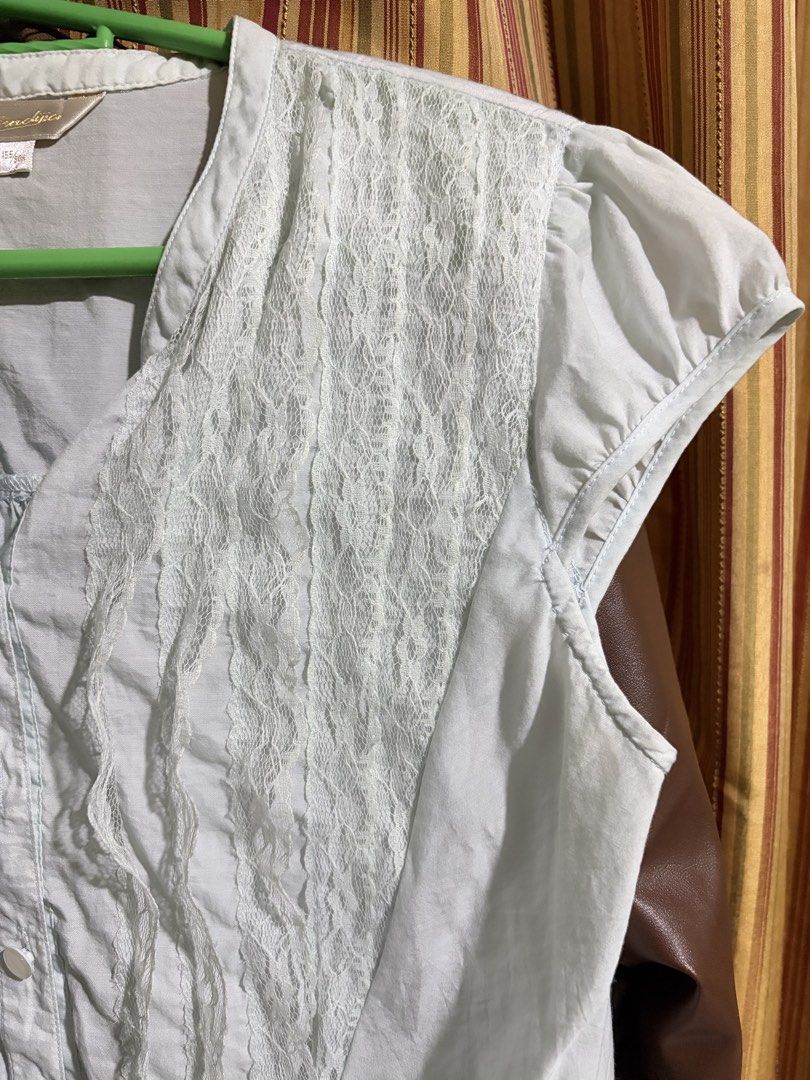 White lace front sleeveless button-up blouse (Category: Sleeveless) located in Rizal. Submitted by iyaahbells (Listing ID 1469166309, Image 3). Description: Color: White Style: Sleeveless top with delicate front lace panels Details: Button closure at neckline and gathered pleats at lower waist Fit: Lightweight fabric with matching side tie strings Size: Tagged 155/80A xs/s Condition: Great pre-loved condition (ready to wear!).
