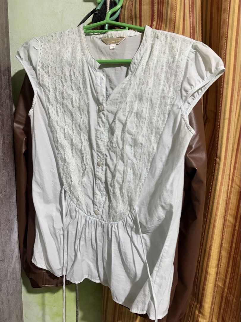 White lace front sleeveless button-up blouse (Category: Sleeveless) located in Rizal. Submitted by iyaahbells (Listing ID 1469166309, Image 1). Description: Color: White Style: Sleeveless top with delicate front lace panels Details: Button closure at neckline and gathered pleats at lower waist Fit: Lightweight fabric with matching side tie strings Size: Tagged 155/80A xs/s Condition: Great pre-loved condition (ready to wear!).