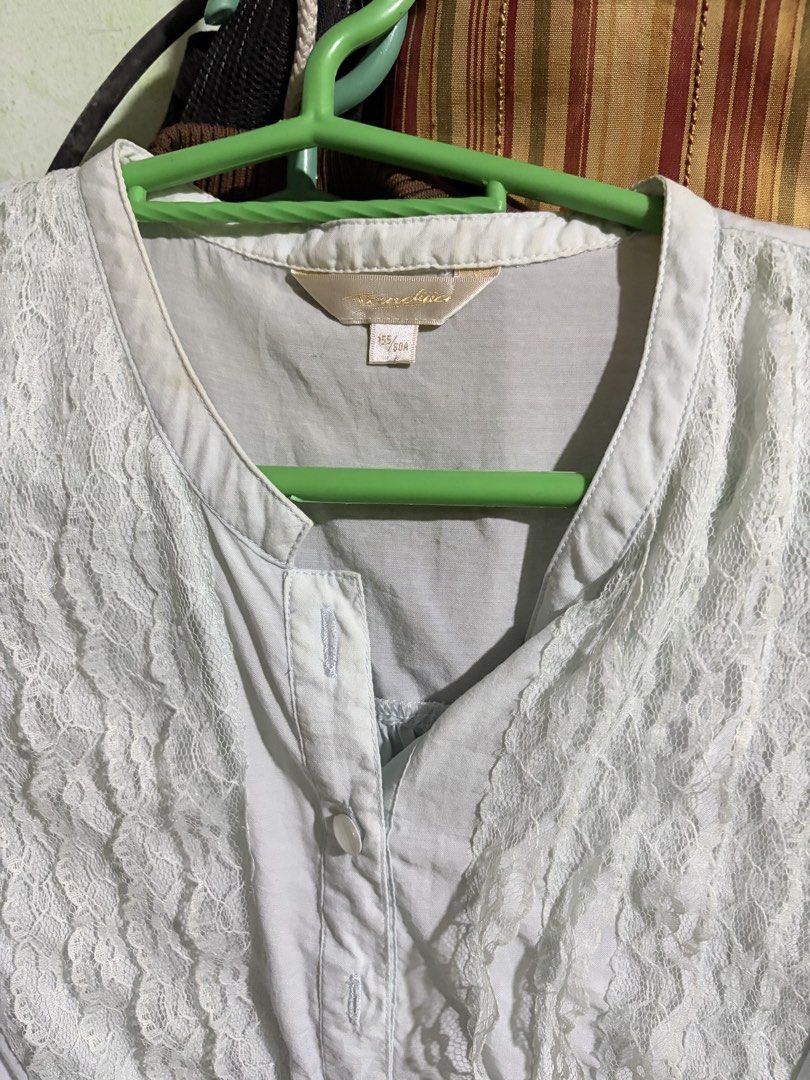 White lace front sleeveless button-up blouse (Category: Sleeveless) located in Rizal. Submitted by iyaahbells (Listing ID 1469166309, Image 2). Description: Color: White Style: Sleeveless top with delicate front lace panels Details: Button closure at neckline and gathered pleats at lower waist Fit: Lightweight fabric with matching side tie strings Size: Tagged 155/80A xs/s Condition: Great pre-loved condition (ready to wear!).