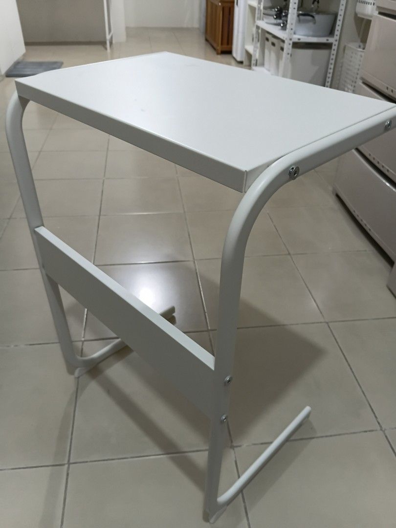 White Metal Laptop Stand Desk Riser (Category: Office Furniture & Fixtures) located in Makati City. Submitted by mkdmaniego (Listing ID 1469241563, Image 3). Description: - Color: Clean white finish that matches any room setup - Material: Sturdy curved metal tube frame for desk stability - Extra Storage: Includes a small middle shelf for pens, a notebook, or small accessories - Compatibility: Standard size fits most laptops and small monitors kin