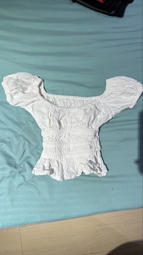 White Off-shoulder Ruffled Smocked Crop Top (Category: Blouses) located in Caloocan City. Submitted by mariettani10615 (Listing ID 1469360917, Image 1). Description: Fits xs-s frame! Used a few times, no last price na po. :).
