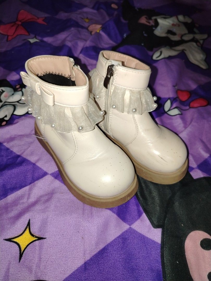 White pearl ruffle girls boots (Category: Babies & Kids Fashion) located in Manila. Submitted by nesacake (Listing ID 1469295906, Image 2). Description: - Style: White ankle boots with cute side bow, pearl trim, and sheer ruffles - Sole & Closure: Chunky brown sole with convenient side zipper for easy wear - Condition: Clean overall with minor scuffs on the toe area - Perfect for adding a sweet, feminine touch to your outfit!.