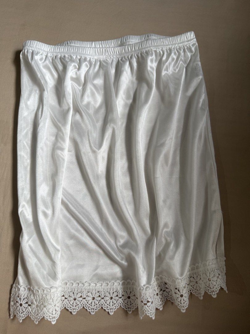White Satin Lace Half Slip Skirt Extender (Category: Skirts) located in Cagayan de Oro. Submitted by redbluerider (Listing ID 1469167953, Image 3). Description: - Color: Classic White - Material: Smooth, silky satin - Fit: Stretchy elastic waistband for comfort - Design: Delicate floral lace trim and convenient side slit for easy movement - Purpose: Provides smooth coverage under skirts and dresses.