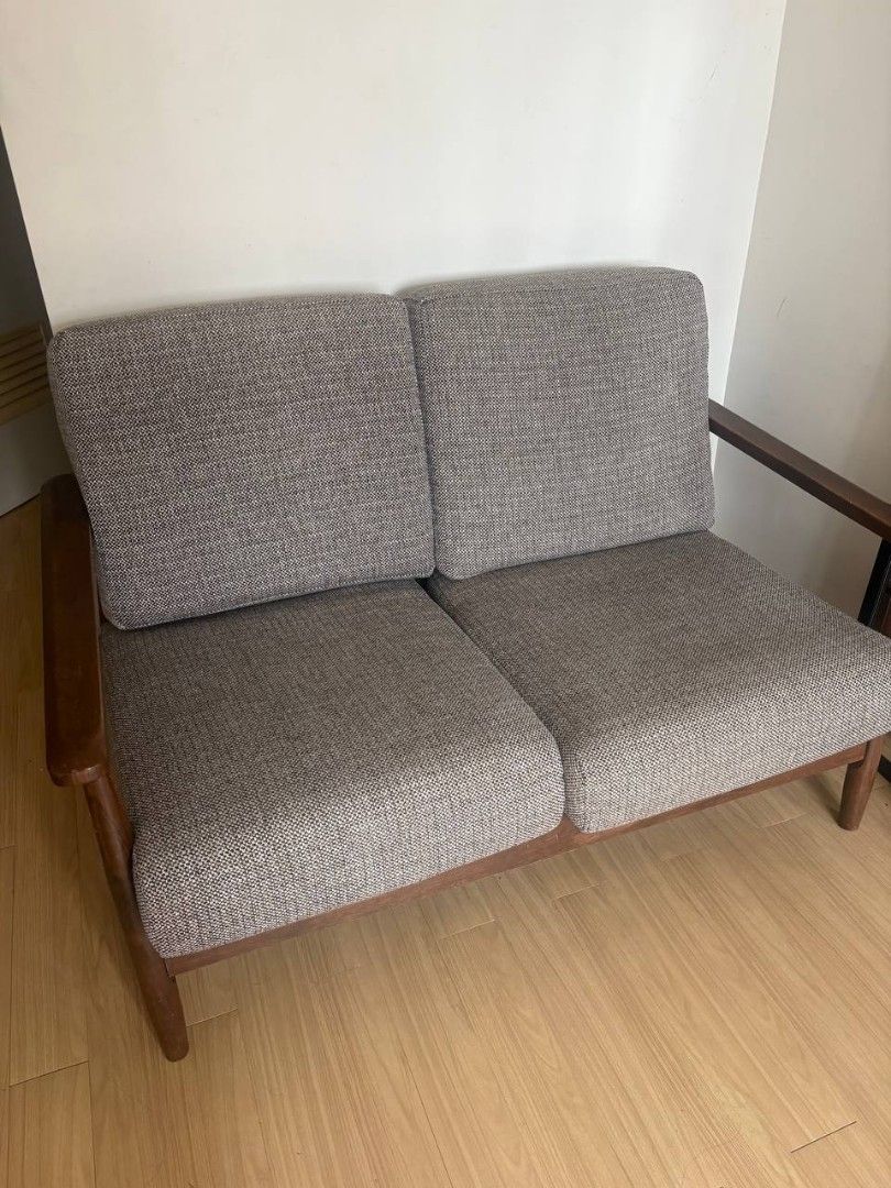 Wooden Frame 2 Seater Sofa (Category: Sofas) located in Pasig City. Submitted by indigo.j (Listing ID 1469198146, Image 1). Description: - 2-seater sofa with dark wood frame and stylish tapered legs - Textured grey tweed upholstery in clean condition (no stains or tears) - Firm, removable cushions for easy cleaning - Sturdy wooden armrests for extra comfort - Compact size, perfect for small living rooms or studio apartments - Delivery via lalamov